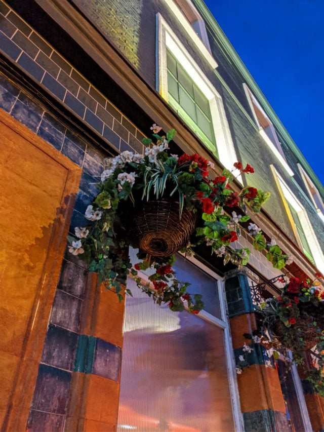 hanging flower basket outside pub taken on google pixel 4 xl with night mode
