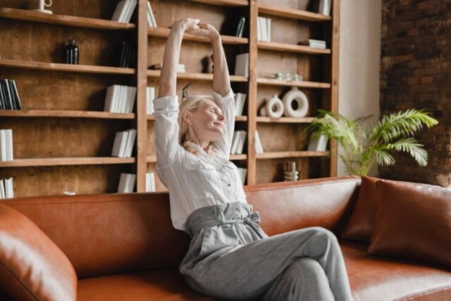 Lady stretching on a tan sofa