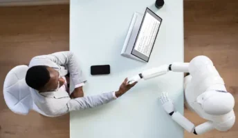 Professional man shaking the hands of a robot